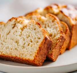 Cottage Cheese Banana Bread sliced on marble with creamy golden crumb