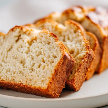 Cottage Cheese Banana Bread sliced on marble with creamy golden crumb