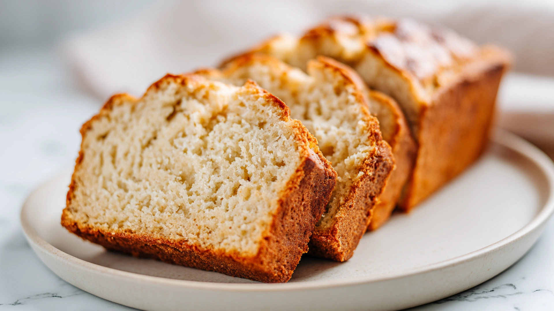 Cottage Cheese Banana Bread sliced on marble with creamy golden crumb