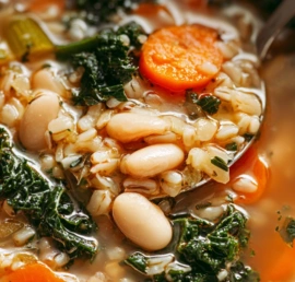 Sardinian longevity soup served in a modern white bowl with beans, barley, vegetables, and herbs in bright natural light.