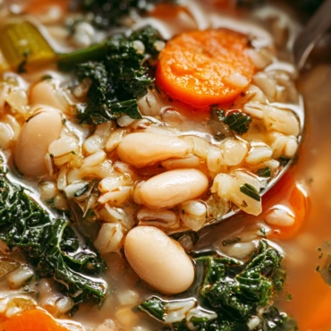 Sardinian Longevity Soup: 5 Powerful Benefits for a Healthier Life 5 Sardinian longevity soup served in a modern white bowl with beans, barley, vegetables, and herbs in bright natural light.