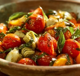 Rustic Tuscan tomato salad served in a white ceramic bowl with fresh basil and chickpeas