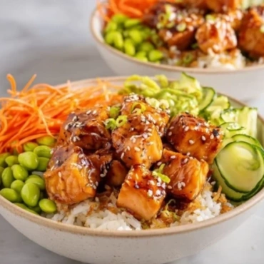 Plate of crispy salmon served with fluffy rice and garnished with herbs