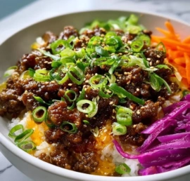 A delicious bowl of Hot Honey Beef garnished with vegetables and cilantro.