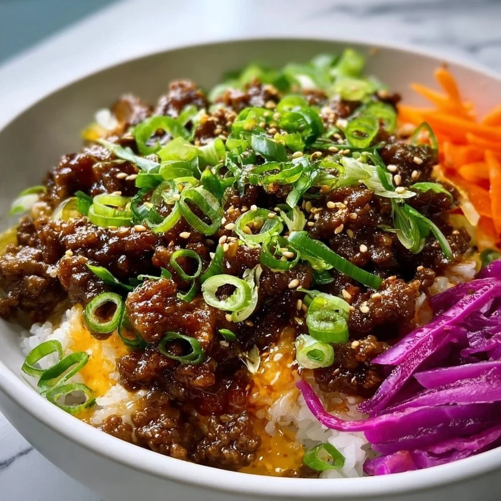 A delicious bowl of Hot Honey Beef garnished with vegetables and cilantro.