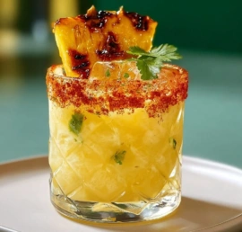 Delicious Roasted Pineapple Margarita in a glass with garnishes