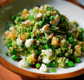 Colorful Spring Pea Feta Couscous Salad with fresh vegetables and feta cheese.