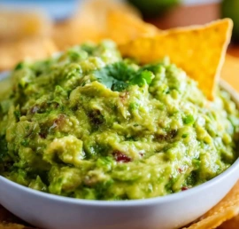 Bowl of authentic guacamole made with ripe avocados and fresh ingredients