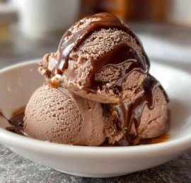 Delicious bowl of Chocolate Frozen Yogurt topped with chocolate pieces and nuts