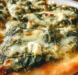 Delicious Pesto Spinach Flatbread Pizza topped with fresh spinach and pesto sauce